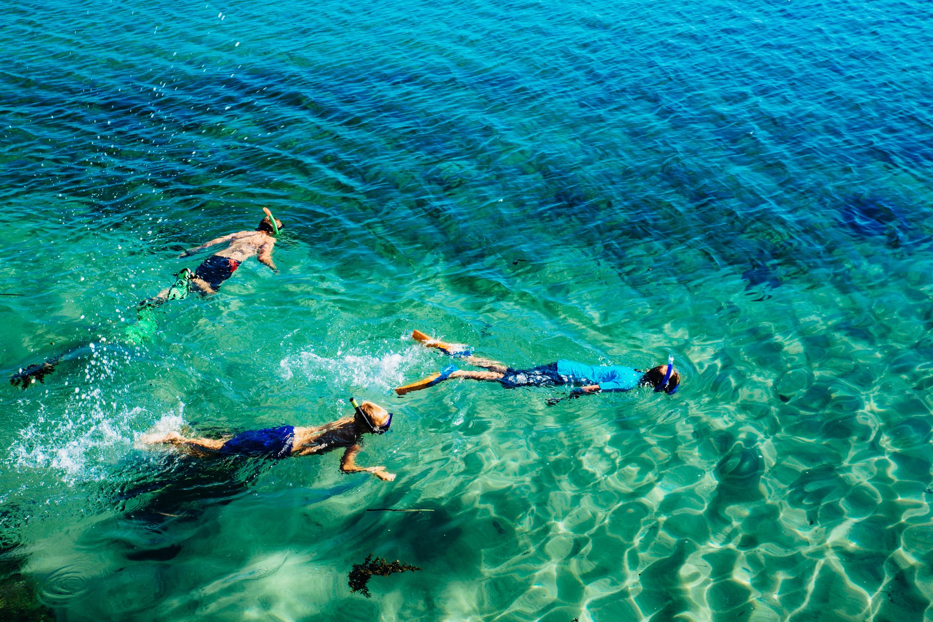 Kids Snorkelling in turquoise water